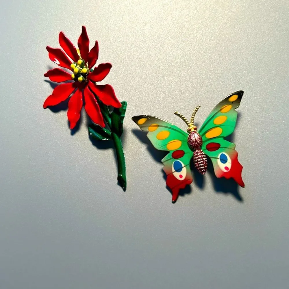 Vintage pointsettia and butterfly enamel on metal brooch set